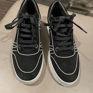 Black suede sneakers with tiny pearl details